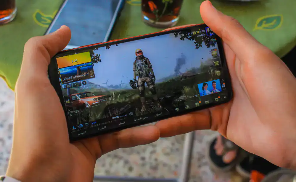 Mobile phone displaying a realistic flight simulator game